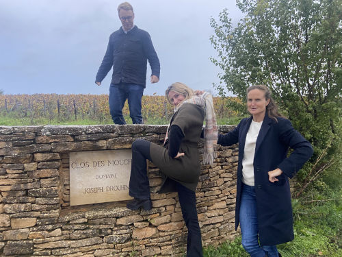 The team posing at the Drouhin wall sign