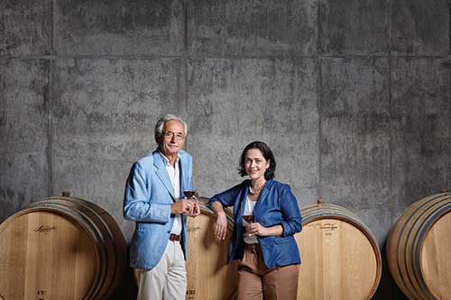 Christian and Andrea
    Sauska stand in front of some barrels in their winery