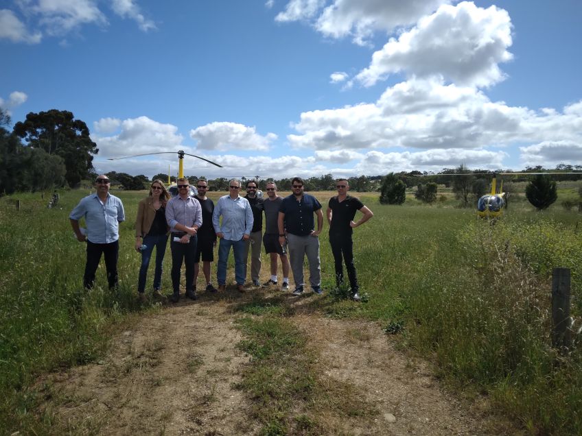 The group standing in front of the helicopter