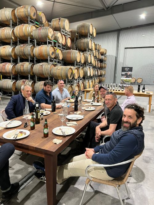 The group sat in the winery at lunch