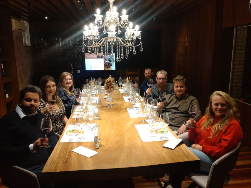 Group wine tasting and dinner in the cellar with big chandelier