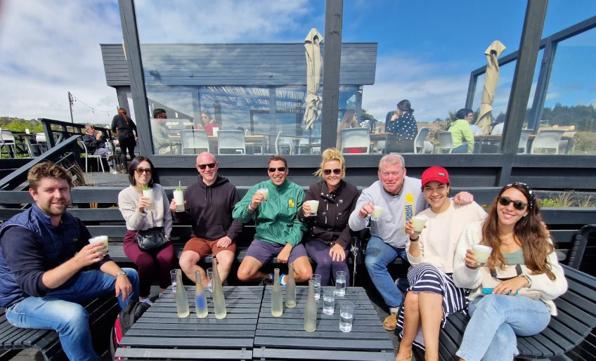 Group drinking pisco sours at coastal bar